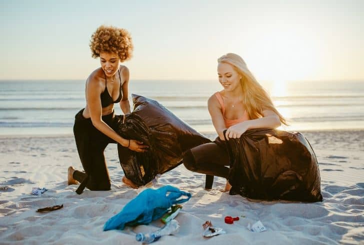 women-cleaning-beach-litter