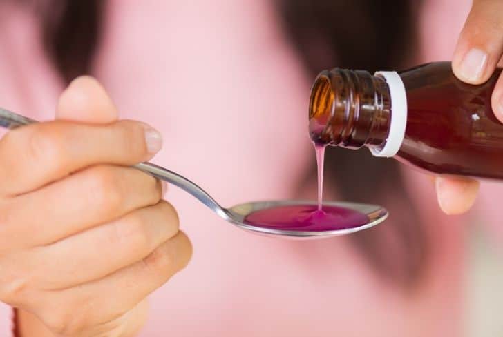 woman-taking-medicine-from-bottle