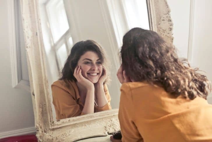 girl-watching-herself-in-mirror