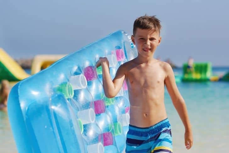 boy-holding-air-mattress