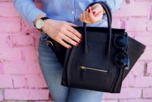 women-holding-black-leather-bag