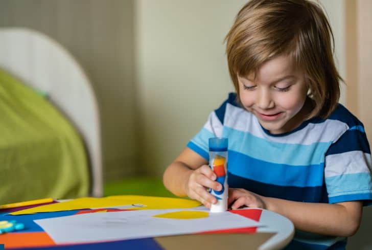 child-making-craft-with-glue-stick