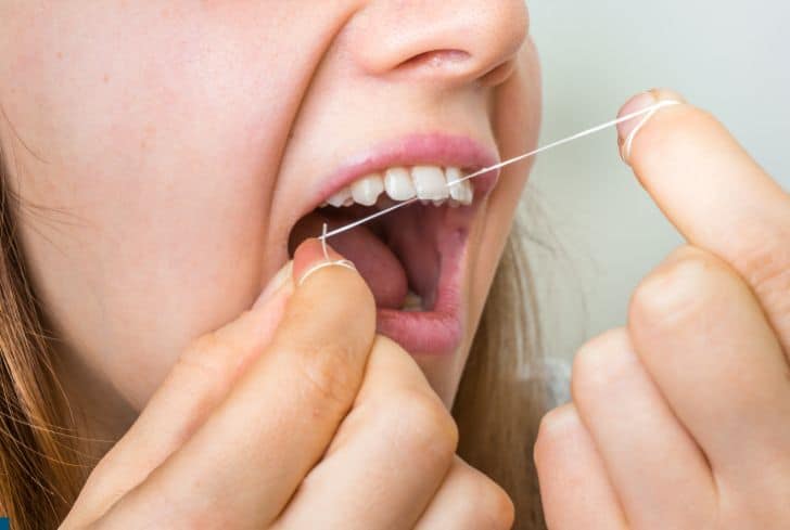women-using-dental-floss