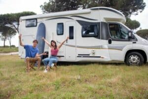 couple-sitting-next-to-RV